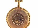 a gold pocket watch with a chain on a white background