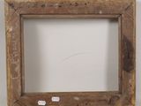 an old wooden picture frame with a sticker on the bottom of it
