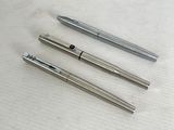 three different types of pens are lined up on a table