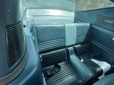 une photo de l'intérieur d'une voiture avec des sièges en cuir bleu