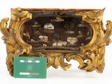a gold frame with a picture of a ship in it