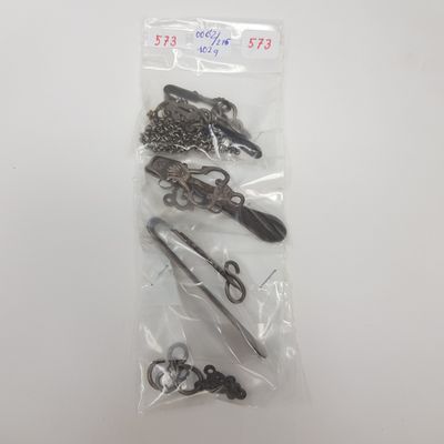 several pairs of scissors are in a plastic bag on a table