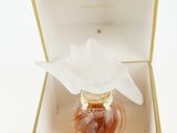 a bottle of perfume in a box with a flower on it