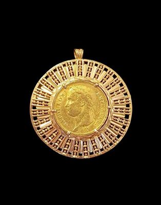 a close up of a gold coin on a black background