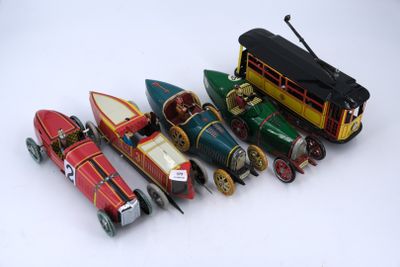 a lot of toy cars and a bus on a white surface