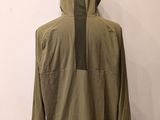 the back view of a green jacket on a mannequin stand
