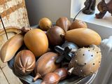 a bowl of gourds on a table in a room