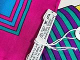 purple, blue, and green striped necktie with a tag on it
