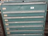 a green tool cabinet with a lot of drawers on it