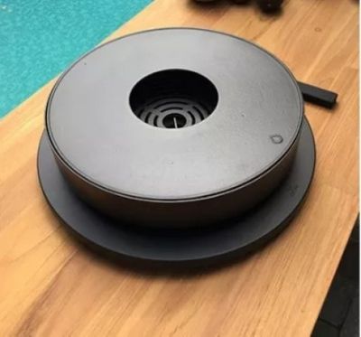 an image of a black round object on a wooden table