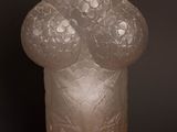a frosted glass vase on a table with a gold chain