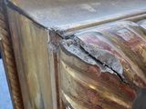 a close up view of a gold painted console