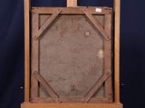 an old wooden easel with a painting on it against a blue background