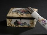 a small box with a decorative handle and a decorative handle on it