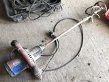 a drill and other tools on the floor in a garage