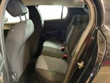the back seat of a car with the door open in a car showroom