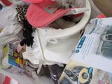 a pile of baby items in a box on the floor