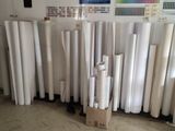 many rolls of white paper on the floor in a room