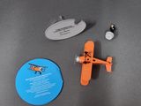 a small toy airplane sitting on a table next to a mirror