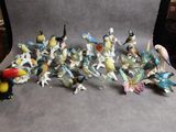 many figurines of birds that are sitting on a table