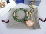 a necklace, bracelet, and ring with a pearl on it