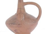 a brown vase that is sitting on a white surface