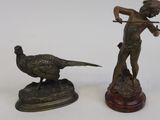 deux figurines en bronze représentant un garçon et un faisan