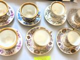 six tasses et soucoupes sont alignées sur une table