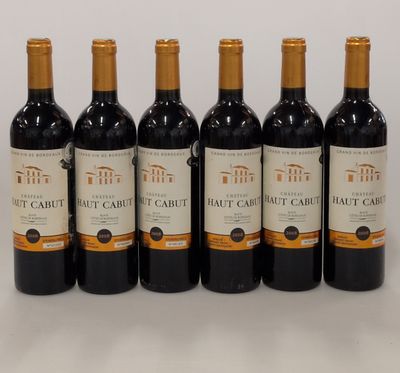 six bottles of red wine lined up in a row