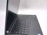 a black laptop with a red button on the keyboard