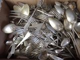 a lot of silver spoons and forks in a box