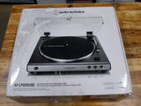an open box of audio technicas on a wooden table