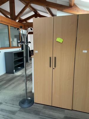 a tall wooden cabinet in the middle of a room