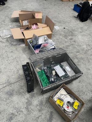 many boxes of assorted electronics on the floor