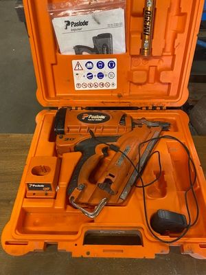 an orange tool case with a corded nail gun in it