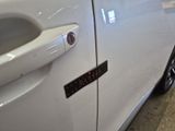 a close up of a car door handle with a sticker on it