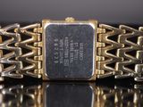 an image of a gold watch with a black face