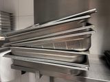 several pans are stacked on top of each other in a kitchen