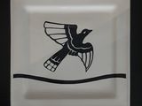 a black and white plate with a bird on it
