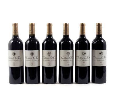 four bottles of red wine are lined up on a white surface