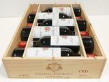 bottles of red wine in a wooden box on a table