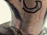 a close up of a metal vase with a design on it