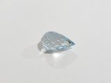 a close up of a blue topaz gemstone on a white surface