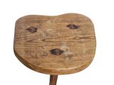 a small wooden stool with a wooden seat on it