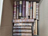 a box full of old books sitting on the floor