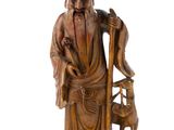 statue of an old man with a dog and a chair