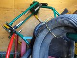 a pile of hoses and other tools in a garage