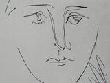 a drawing of a woman ' s face on a piece of paper