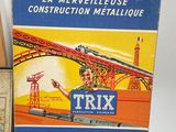 three boxes of tin toys including a train and a box of construction materials