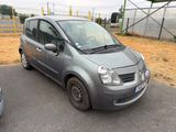a small grey car parked in a parking lot